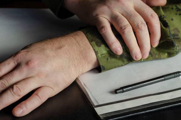 istock Officer's hands, document folder on black desk in close-up. 1313593573