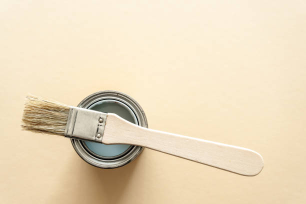 istock A can of paint and a brush on a beige background 1313595162