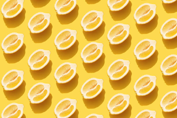 istock Pattern with halves of lemon with shadow on yellow background 1313597496