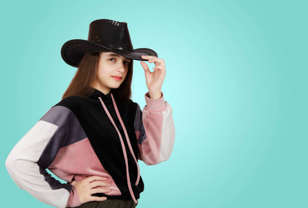 istock teenage girl posing with hat in studio 1313598804