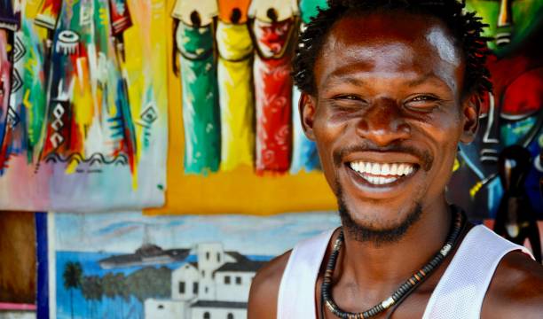 Marigot Bay, St Lucia, May 26, 2011;portrait of rastafarian man holding five EC \\\