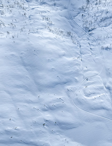 Snow covered arctic mountain terrain. Top down aerial view.
