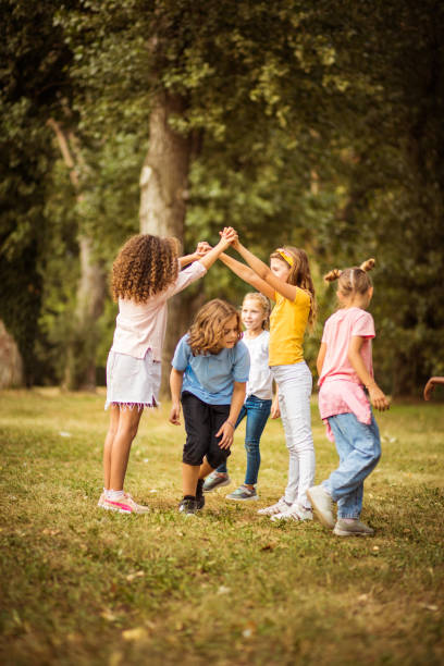 istock Large group of school kids having fun in nature. 1313603606