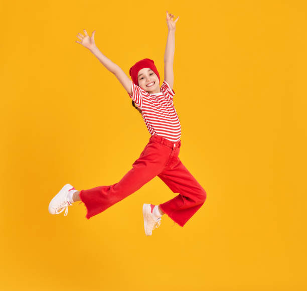 istock Excited kid in red clothes jumping high 1313605658