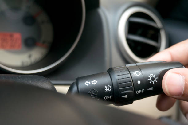 istock Man driving hands pushing turn on light switch on steering wheel in the car selective focus. safety driving. 1313610226