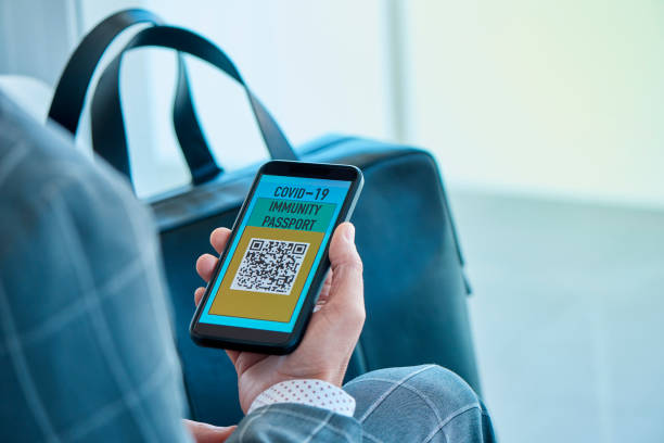 istock man with an electronic covid-19 immunity passport 1313613148