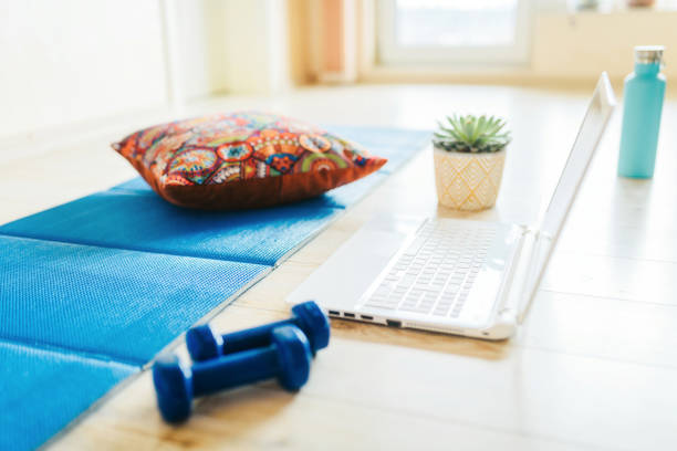 istock Preparing for training online. Mat, dumbbell and laptop. 1313613153