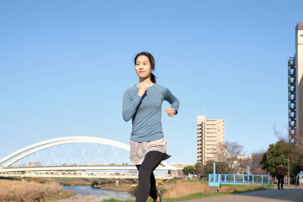istock Woman running on riverbank 1313614856