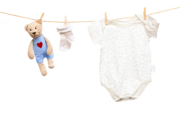 istock Baby clothes on a clothesline on white  background - Image 1313614972