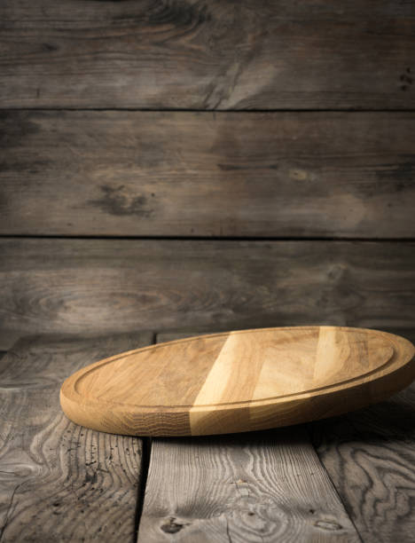 istock empty round wooden cutting kitchen board on wooden background 1313615918
