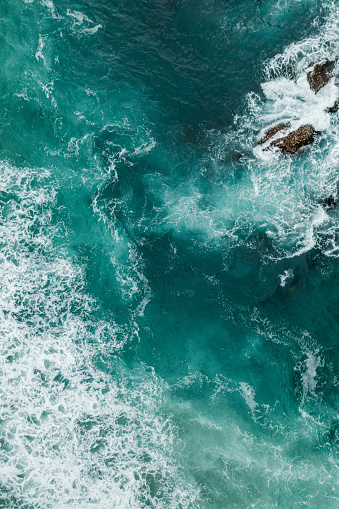 Bali, aerial shot of the turquoise ocean surface and waves.