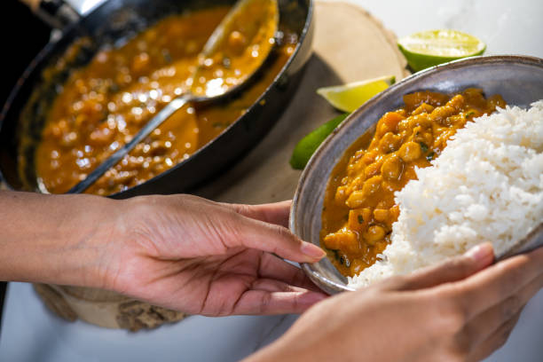 istock Woman chickpea curry with rice in bowl 1313617053