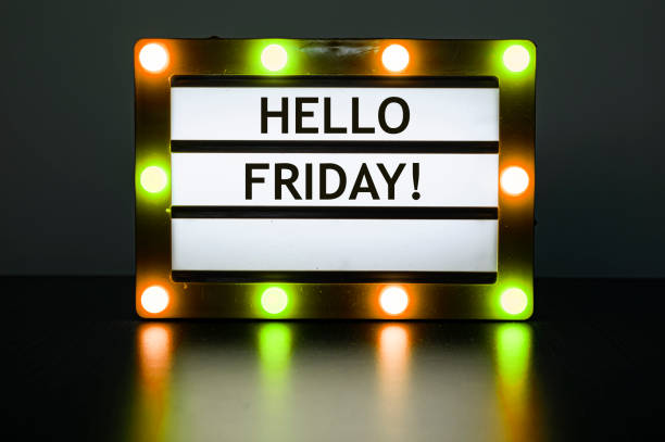 istock Lightbox with yellow and orange lights in dark room with words - Hello Friday! 1313617111