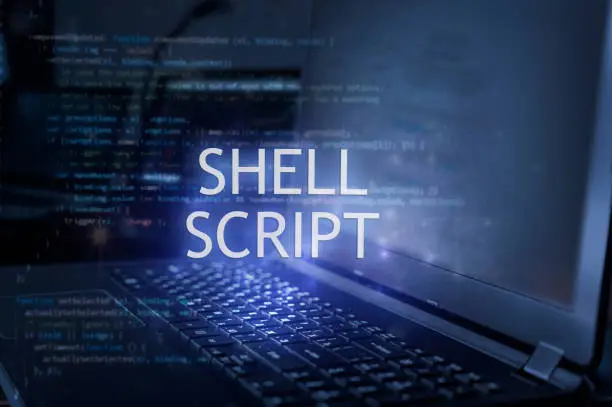 Photo of Shell script inscription against laptop and code background. Technology concept. Learn programming language.