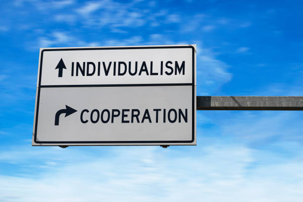 istock Road sign with words individualism and cooperation text 1313617216