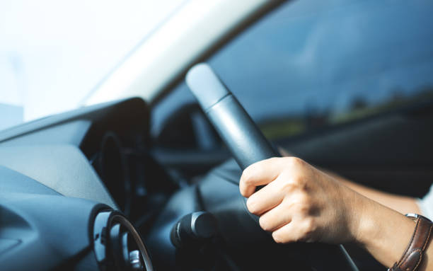 istock a woman holding steering wheel while driving a car 1313617277