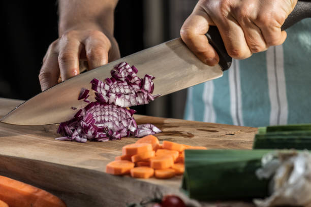 istock Woman cutting onion on chopping board 1313617591