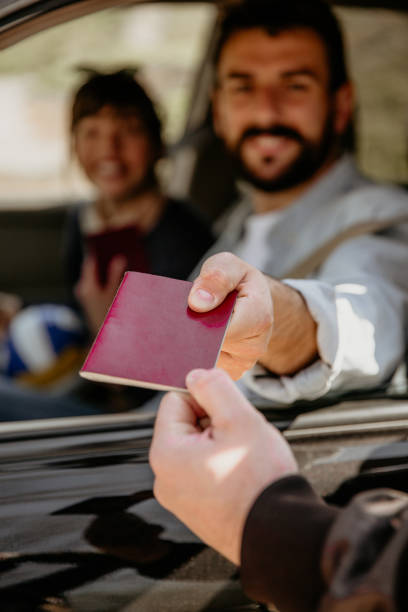istock Man giving a passport on border 1313617633