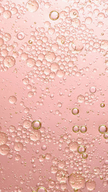 oil with bubbles on coral background. Abstract background.