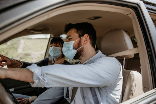 istock Side view of a couple in car 1313619645