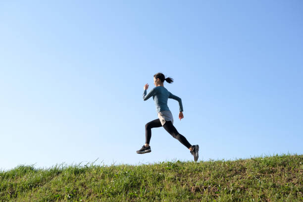Woman running on riverbank