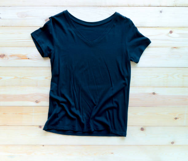 istock Black tshirt mockup on brown wooden background. Template, flat lay 1313620092