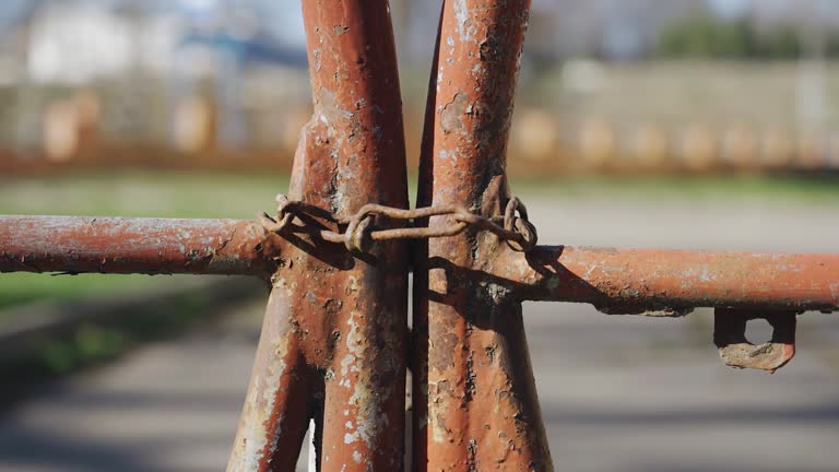 The old metal gate is locked and chained. The camera shoots close up gradually approaching the object