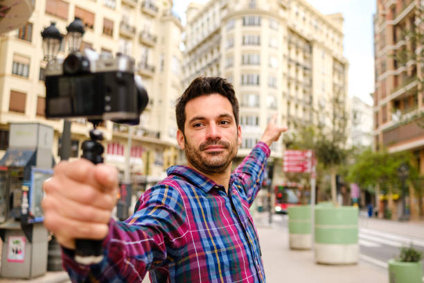istock man records a video with a camera in a city 1313624515