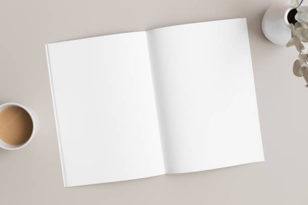 istock Open magazine mockup with a cup of coffee and a eucalyptus on the beige table. 1313626202