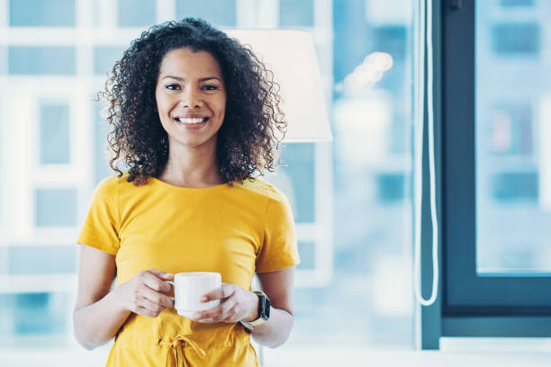 istock Happy young woman with coffee cup 1313628518