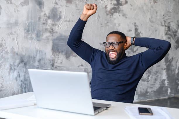 istock Good luck concept with overjoy black man at laptop 1313631938