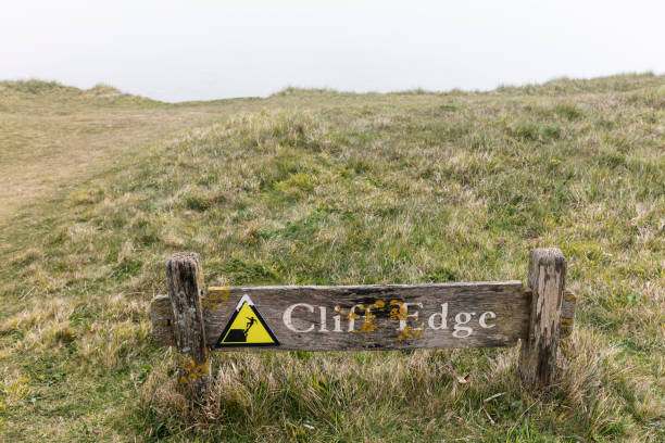 Sign: Danger unstable cliffs keep clear, seen in  Reculver, Kent, England, UK