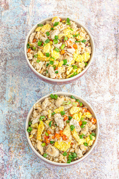 istock Asian Chinese Fried Rice with Chicken, Scrambled Eggs and Vegetables Vertical Photo 1313632138