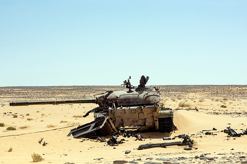 The remains of destroyed tanks and other war equipment at the Wadi Doum war site in the Sahara, northern Chad, close to the Ennedi massif. The sand dunes now cover much of the old war equipment. This is where the last battles of the war between Chad and its northern neighbor Libya took place in 1986/1987 - in 1987, Chad's army was able to push back Libyan troops in the so-called 