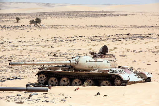 The remains of destroyed tanks and other war equipment at the Wadi Doum war site in the Sahara, northern Chad, close to the Ennedi massif. The sand dunes now cover much of the old war equipment. This is where the last battles of the war between Chad and its northern neighbor Libya took place in 1986/1987 - in 1987, Chad's army was able to push back Libyan troops in the so-called \