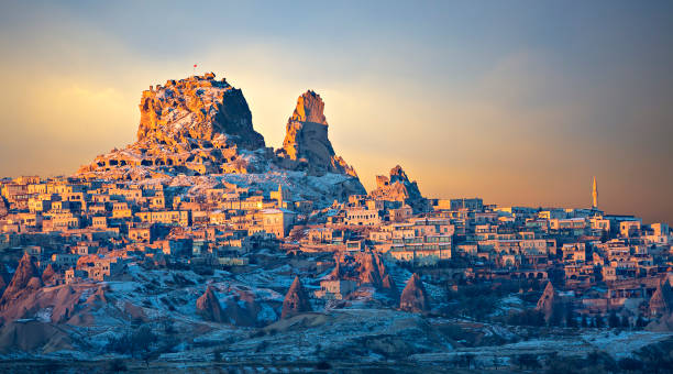Town of Uchisar at the sunrise, Cappadocia, Turkey Uchisar town located around tall volcanic rock formations, Cappadocia, Turkey uchisar stock pictures, royalty-free photos & images