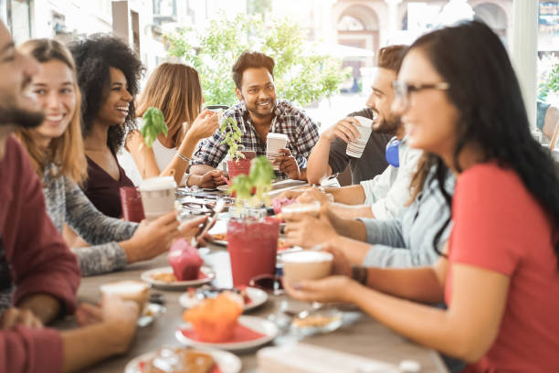 istock Young multiracial people eating brunch and drinking smoothies at bar restaurant - Focus on asian man face 1313635530