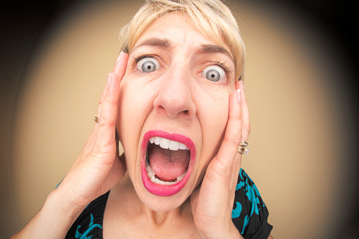 A humorous fisheye image of a screaming woman.
