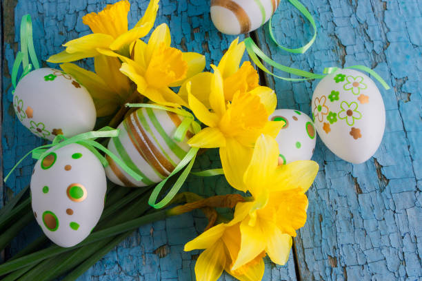 istock Colored decorative Easter eggs and a bouquet of yellow narcissus 1313635910