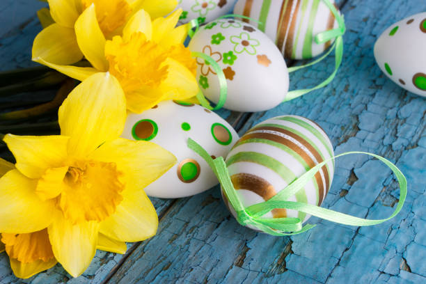 istock Colored decorative Easter eggs and a bouquet of yellow narcissus 1313636009