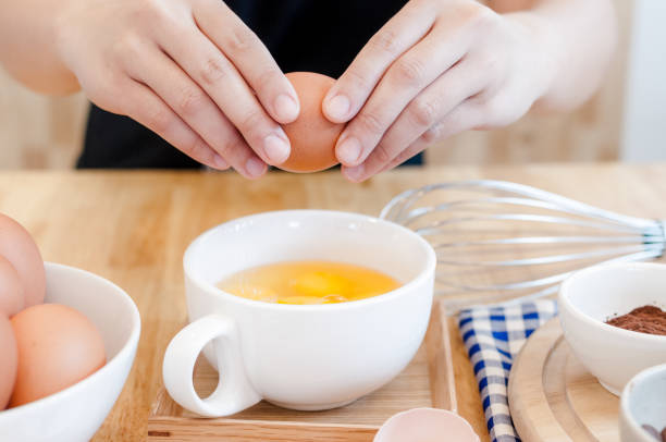 istock Man in the kitchen cooking a dough. Hands breaks an egg into a bowl ,hands pouring bitten egg 1313636748