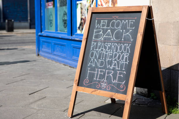 istock Welcome back message on an A-board on the pavement outside a shop 1313636792