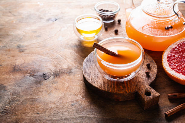 istock Grapefruit tea with spices and honey in a glass cup and teapot. 1313636946