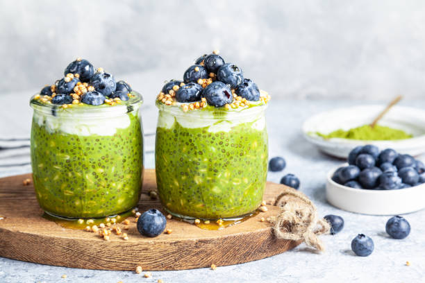 overnight matcha chia oats are topped with yogurt and blueberries. - vitality food food and drink berry fruit imagens e fotografias de stock
