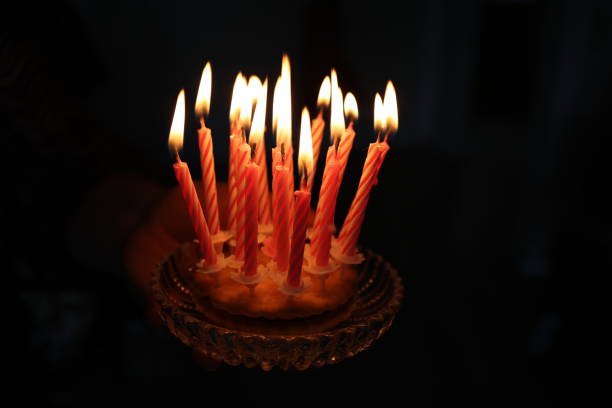 istock Small cake with candles on a dark background 1313638150