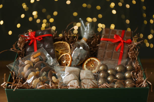 istock Box with chocolate and sweets against blurred lights, closeup 1313638546