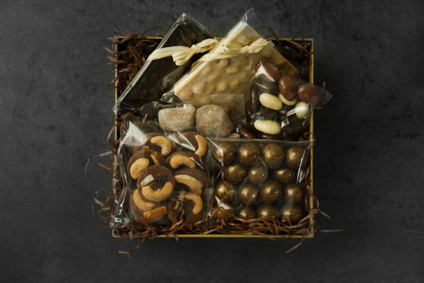 istock Box with chocolate and sweets on dark grey table, top view 1313638619