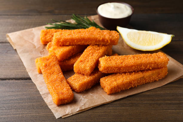 istock Fresh breaded fish fingers served on wooden table 1313638771