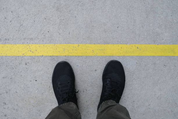 istock A man with black shoe and yellow line 1313639437