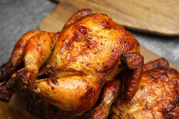 istock Delicious grilled whole chickens on grey table, closeup 1313639586